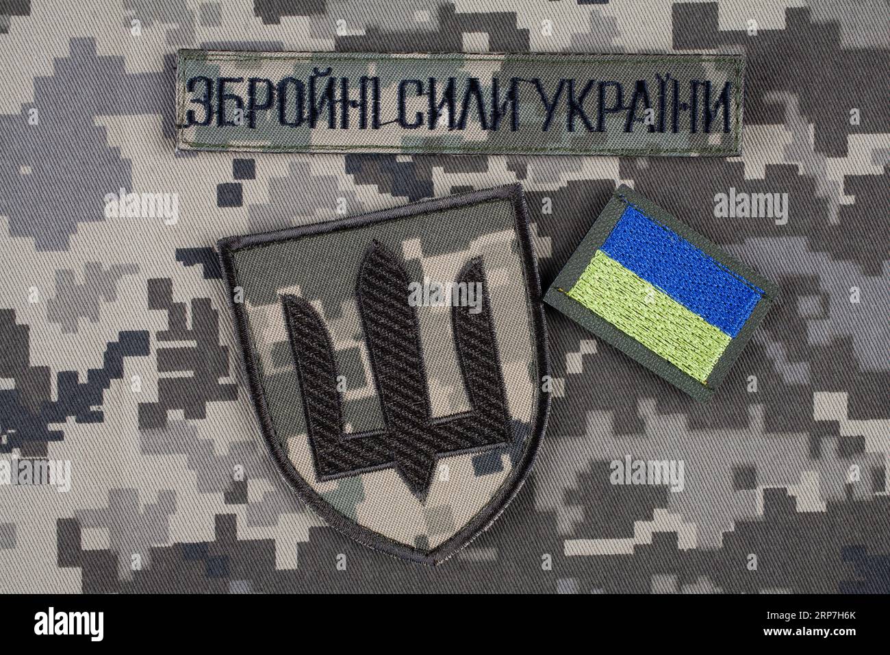 KYIV, UKRAINE - October 6, 2022. Russian invasion in Ukraine 2022. Ukraine Army uniform insignia badges on camouflaged uniform background. Text in ukr Stock Photo