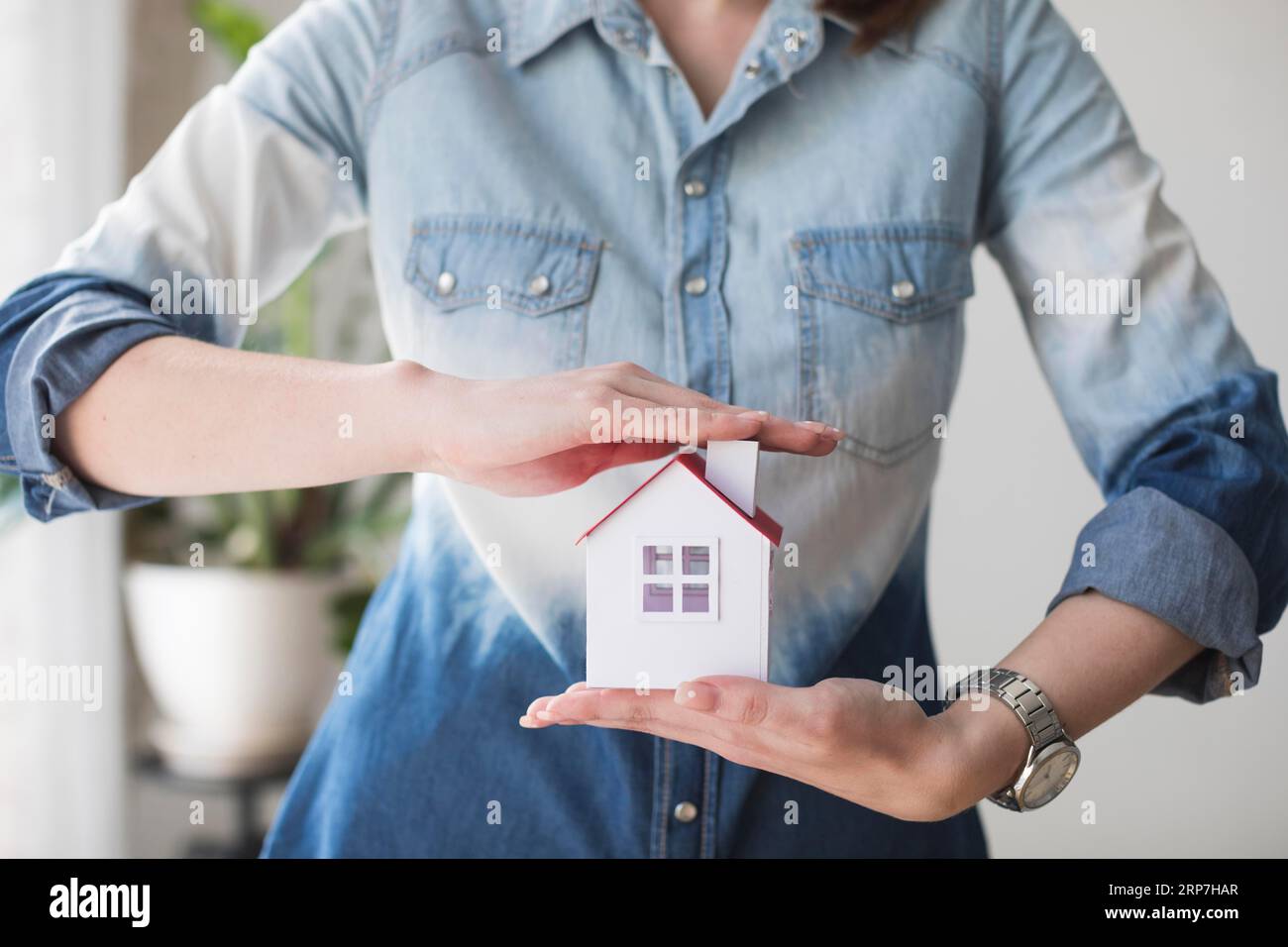 Midsection woman protecting house model office Stock Photo