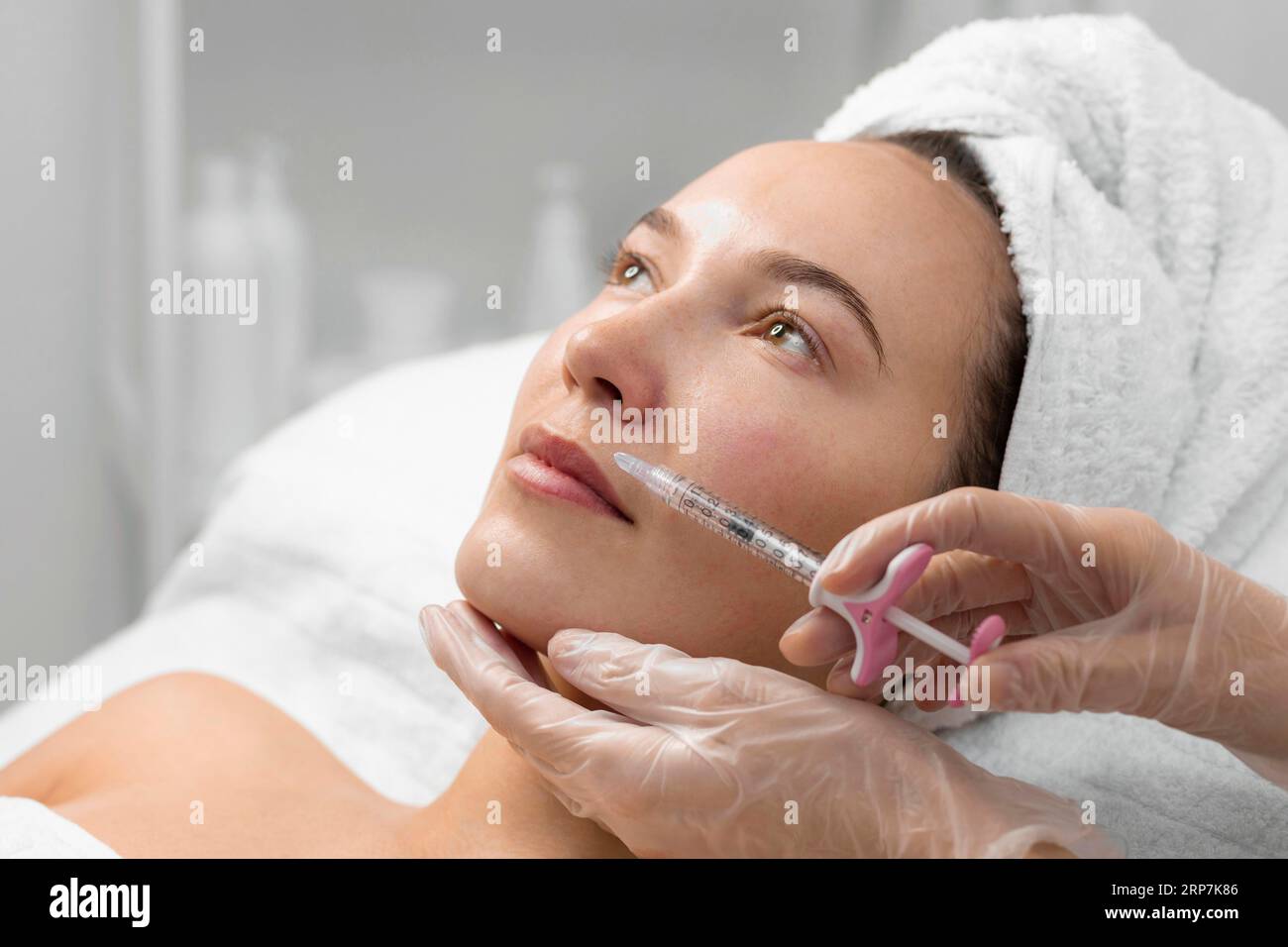 Beautician doing filler injection female client Stock Photo