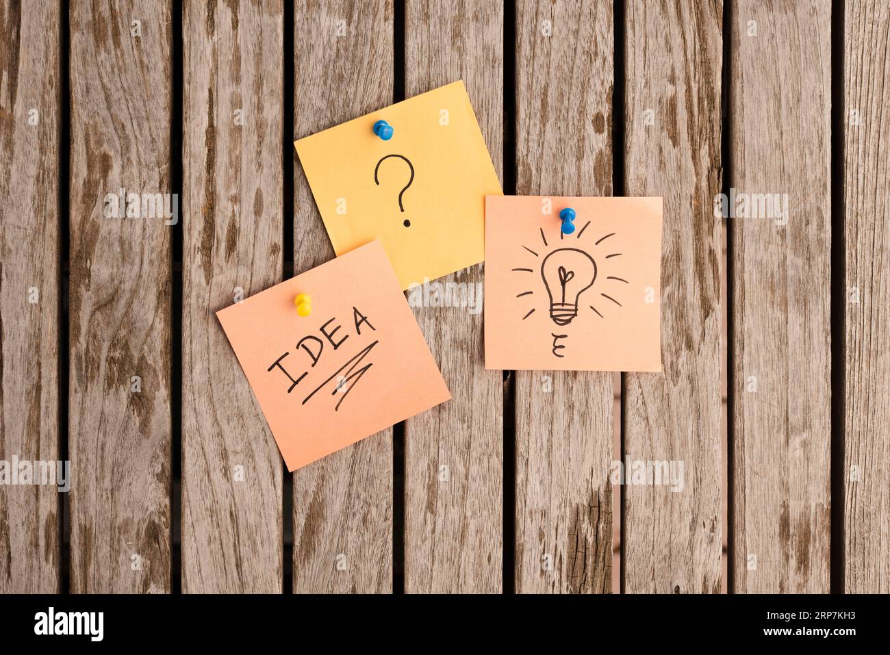 Adhesive notes attached with colorful push pins bulletin board Stock