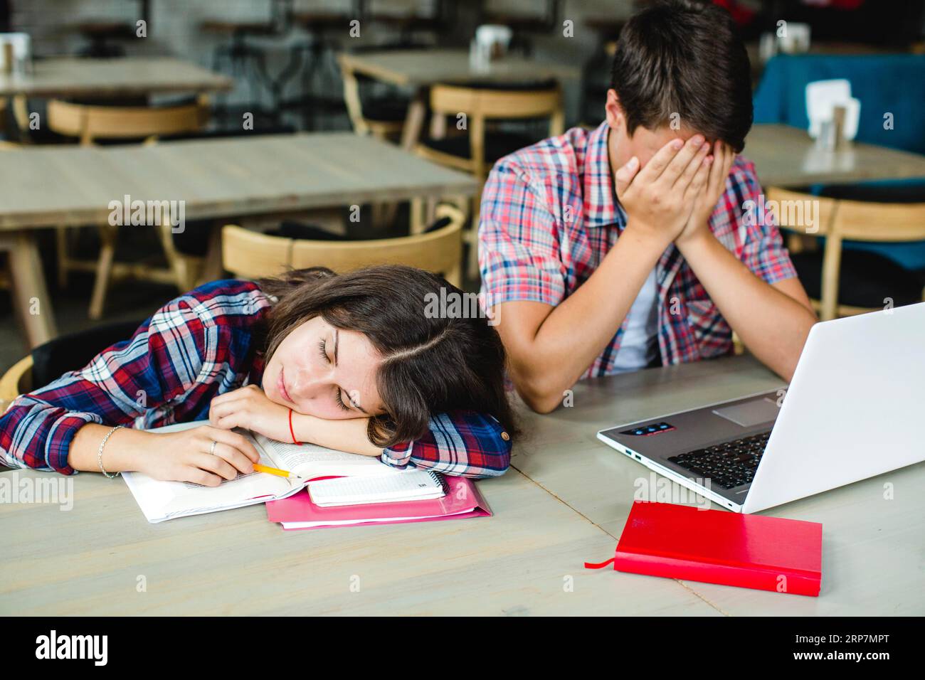 Doing Homework Exhausting Exhausted students desktop Stock Photo - Alamy