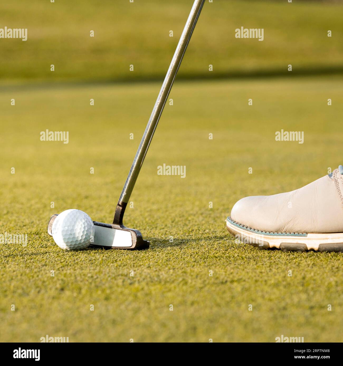 Man using club hit golf ball Stock Photo