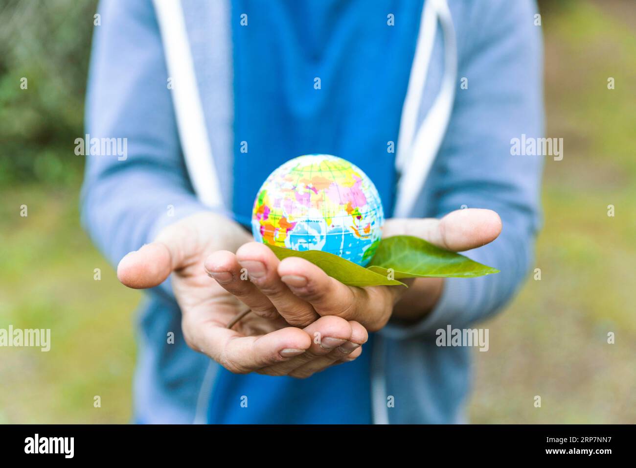Man holding sphere palm hand with leaf Stock Photo