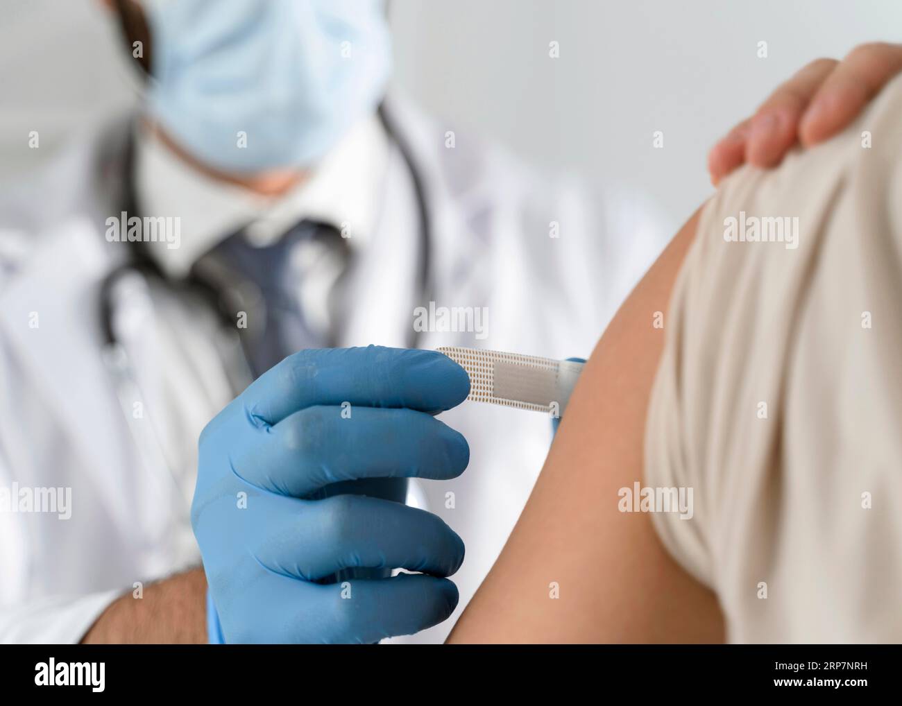 Man putting bandage young woman s arm Stock Photo