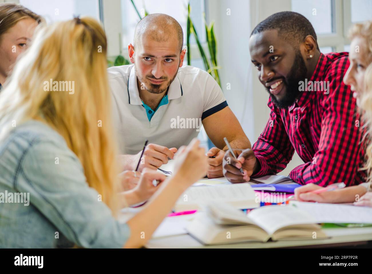 People table studying sharing ideas Stock Photo - Alamy