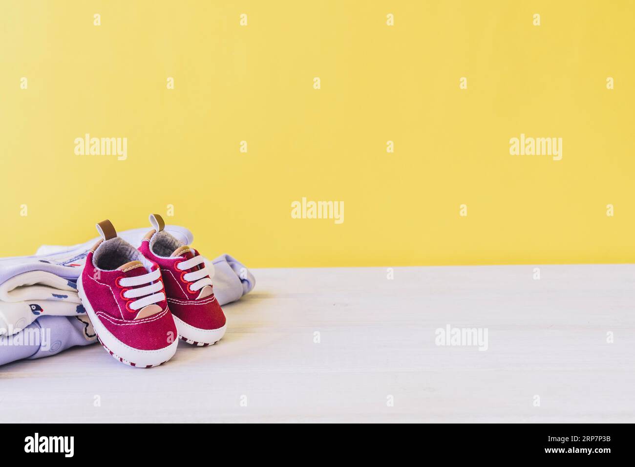 Newborn concept with shoes clothes Stock Photo - Alamy