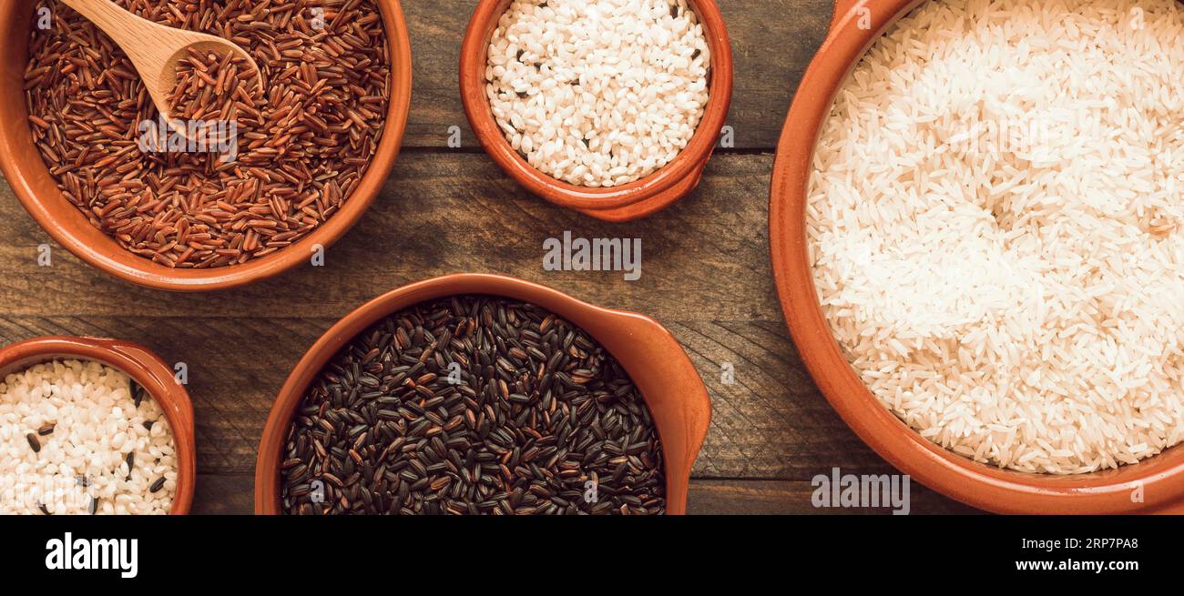 Red brown white rice bowls wooden background Stock Photo