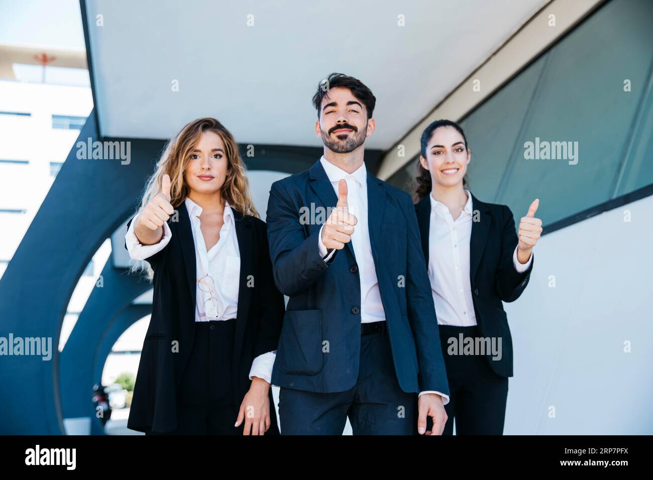 Team architects making thumbs up gesture Stock Photo