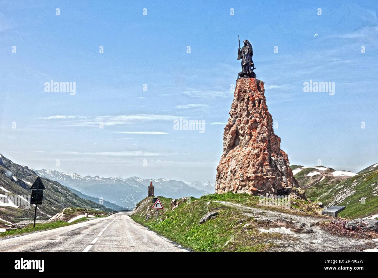 Photo with reduced dynamic saturation HDR of mountain pass alpine mountain road alpine road pass road pass above tree line with right monument with Stock Photo