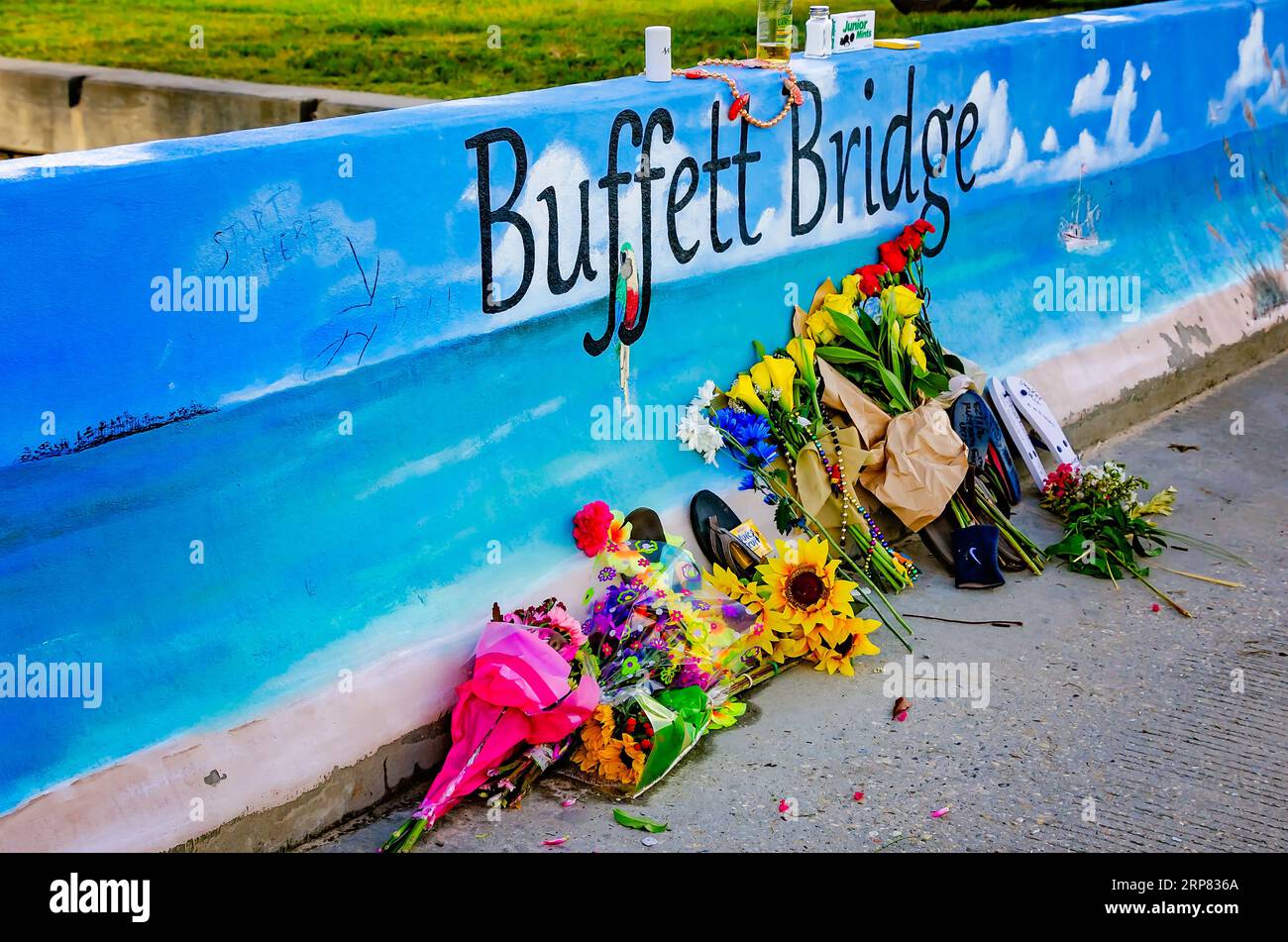 Flowers, salt shakers, and other items are left by Jimmy Buffett fans