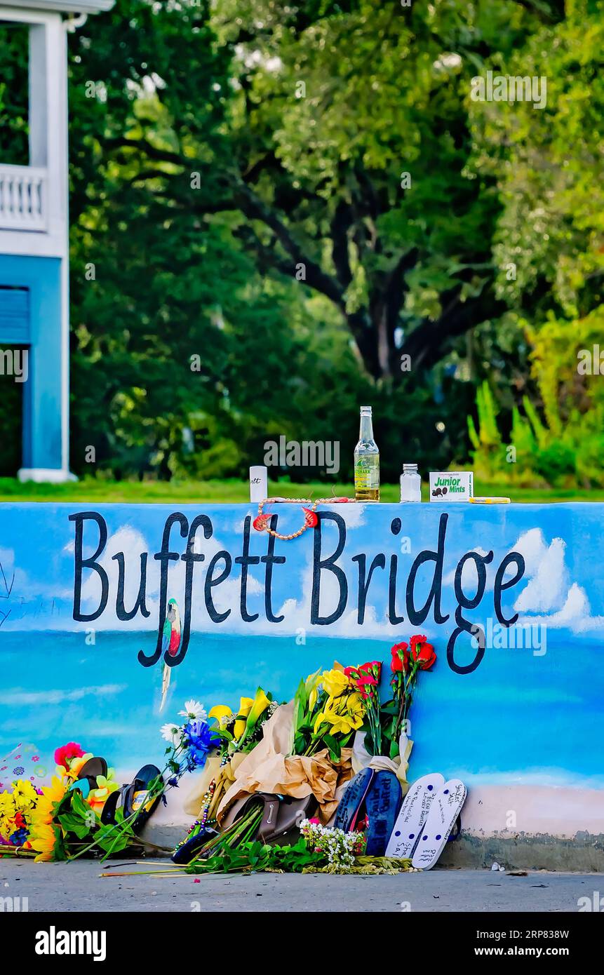 Flowers, salt shakers, and other items are left by Jimmy Buffett fans
