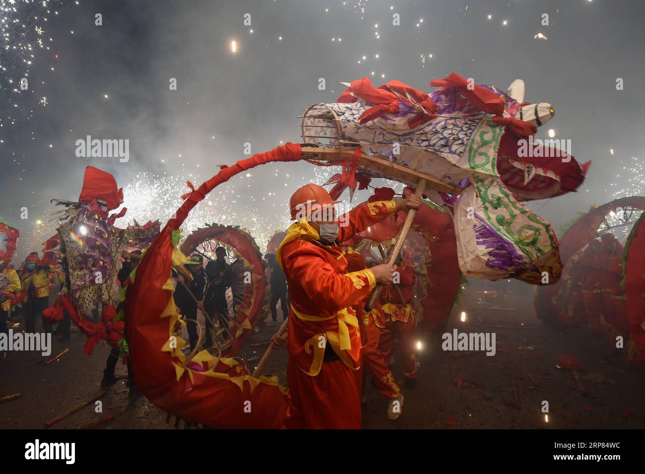 (190218) -- BEIJING, Feb. 18, 2019 (Xinhua) -- People perform dragon dance with a background of firecrackers in Yuqing County, southwest China s Guizhou Province, Feb. 16, 2019. Villagers gathered and performed dragon dances on Saturday to celebrate the upcoming Lantern Festival,which falls on Feb. 19 this year. (Xinhua/He Chunyu) XINHUA PHOTOS OF THE DAY PUBLICATIONxNOTxINxCHN Stock Photo