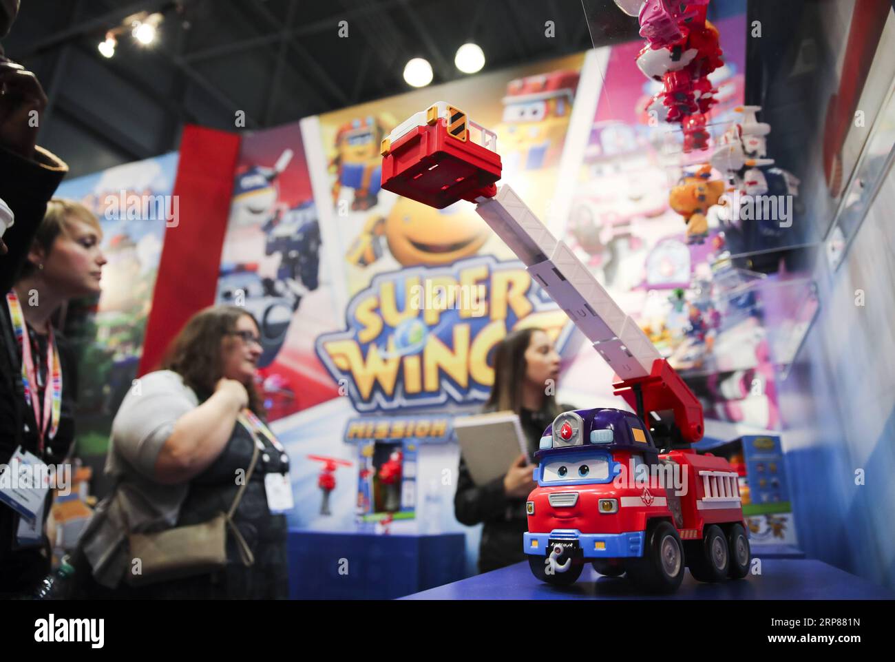 (190221) -- NEW YORK, Feb. 21, 2019 -- Visitors look at toy products of Super Wings at the booth of Alpha Group Co., Ltd., a major animation, toy and entertainment player from Guangdong Province in southern China, during the 116th Annual North American International Toy Fair at the Jacob K. Javits Convention Center in New York, the United States, Feb. 19, 2019. Chinese toy manufacturers, which produce around 75 percent of global toys each year, are rising up the value chain from the original role as contract manufacturers to designers and makers of their own brands. ) U.S.-NEW YORK-CHINESE TOY Stock Photo