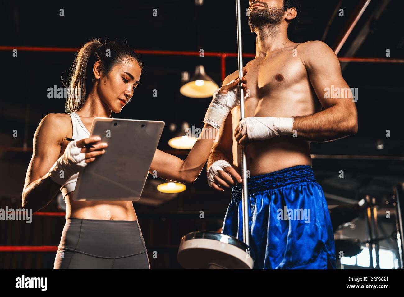 Muay Thai boxer step on weight scale for boxing class designation by