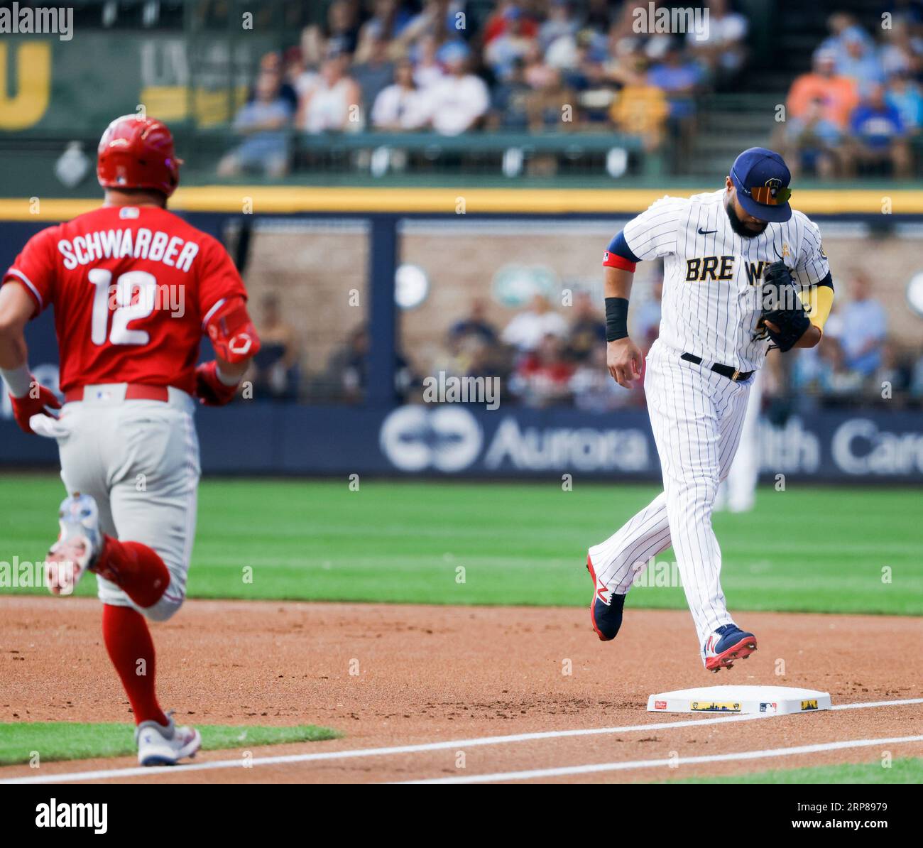 Milwaukee, United States. 03rd Sep, 2023. Milwaukee Brewers first baseman Carlos  Santana (R) forces out Philadelphia Phillies left fielder Kyle Schwarber  (L) after fielding Schearber's ground ball in the first inning of