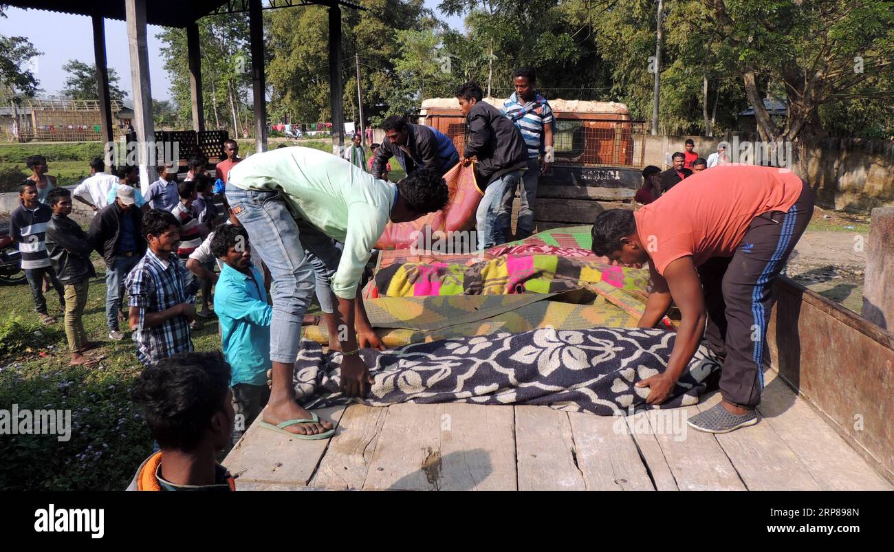 (190222) -- ASSAM, Feb. 22, 2019 (Xinhua) -- Locals arrange bodies of victims who died of consuming liquor mixed with methyl alcohol at Salmara tea garden at Golaghat district of India s north eastern state of Assam on Feb. 22, 2019. The death toll in India s north-eastern state of Assam rose to 22 on Friday, said media reports. Besides, as many as 50 people are being given medical treatment at different hospitals. (Xinhua/Stringer) INDIA-ASSAM-HOOCH TRAGEDY-DEATH TOLL PUBLICATIONxNOTxINxCHN Stock Photo