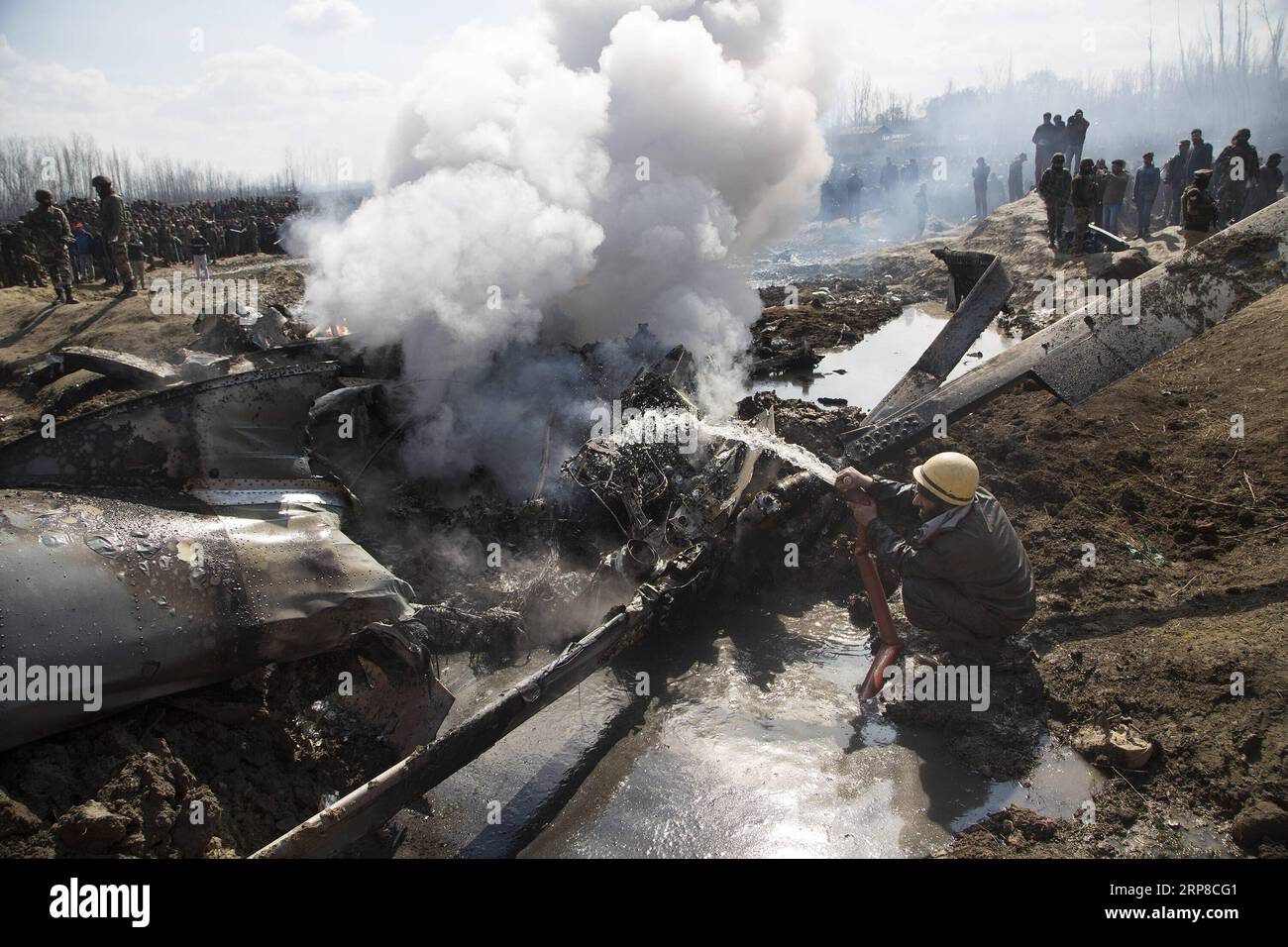 (190227) -- SRINAGAR, Feb. 27, 2019 -- A fire fighter douses the wreckage of an Indian aircraft after it crashed at village Garend Kalan of Budgam, about 34 km south of Srinagar city, the summer capital of Indian-controlled Kashmir, Feb. 27, 2019. A pilot and a co-pilot of Indian Air Force (IAF) were killed after a Mi-17 jet crashed Wednesday in Indian-controlled Kashmir, Indian officials said. Meanwhile, Pakistan army said on Wednesday the Pakistan Air Force has shot down two Indian fighter jets inside Pakistani airspace and ground troops arrested one pilot of the destroyed jet, according to Stock Photo