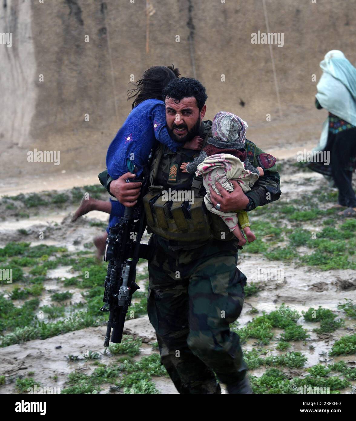(190303) -- KANDAHAR, March 3, 2019 -- An Afghan security force member rescues children during an evacuation operation after a flood in Kandahar province, Afghanistan, March 2, 2019 . At least 20 people were killed and many others went missing after flash floods hit Afghanistan s southern province of Kandahar, authorities said Sunday. STR) AFGHANISTAN-KANDAHAR-EVACUATION OPERATION-FLOOD XinhuaxKabul PUBLICATIONxNOTxINxCHN Stock Photo