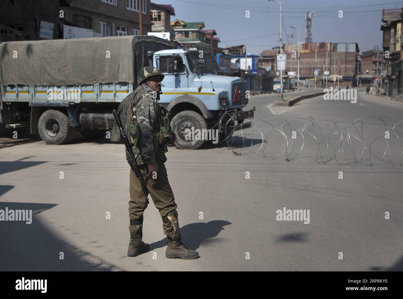 (190310) -- SRINAGAR, March 10, 2019 (Xinhua) -- An Indian paramilitary soldier stands guard near barbed wire barricade during a security lockdown in downtown area of Srinagar, the summer capital of Indian-controlled Kashmir, March 10, 2019. Authorities on Sunday imposed restrictions in parts of Srinagar city to prevent protests after India s anti-terror agency, National Investigation Agency (NIA), summoned key separatist leader and chief cleric of Indian-controlled Kashmir for questioning in an alleged funding case, officials said on Saturday. Mirwaiz Umar Farooq has been asked to appear befo Stock Photo