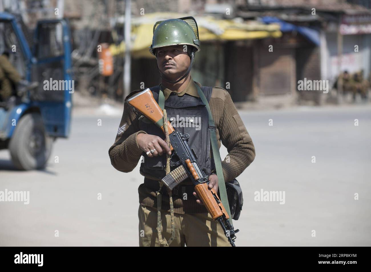 (190310) -- SRINAGAR, March 10, 2019 (Xinhua) -- An Indian paramilitary soldier stands guard during a security lockdown in downtown area of Srinagar, the summer capital of Indian-controlled Kashmir, March 10, 2019. Authorities on Sunday imposed restrictions in parts of Srinagar city to prevent protests after India s anti-terror agency, National Investigation Agency (NIA), summoned key separatist leader and chief cleric of Indian-controlled Kashmir for questioning in an alleged funding case, officials said on Saturday. Mirwaiz Umar Farooq has been asked to appear before the probe agency on Mond Stock Photo