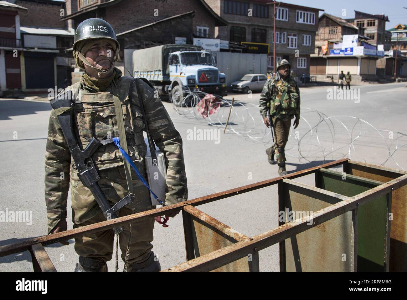(190311) -- BEIJING, March 11, 2019 (Xinhua) -- Indian paramilitary soldiers stand guard near a barricade during a security lockdown in downtown area of Srinagar, the summer capital of Indian-controlled Kashmir, March 10, 2019. Authorities on Sunday imposed restrictions in parts of Srinagar city to prevent protests after India s anti-terror agency, National Investigation Agency (NIA), summoned key separatist leader and chief cleric of Indian-controlled Kashmir for questioning in an alleged funding case, officials said on Saturday. Mirwaiz Umar Farooq has been asked to appear before the probe a Stock Photo
