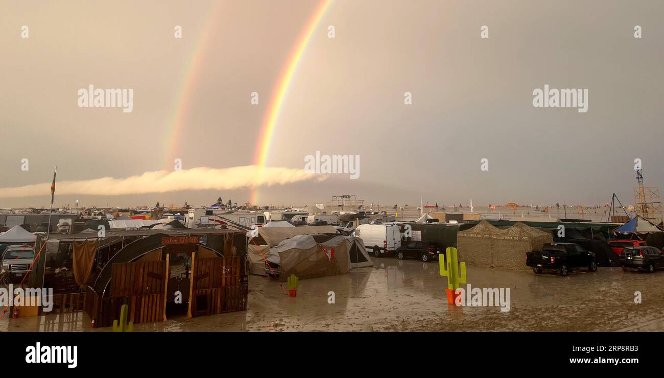 Black Rock, USA. 04th Sep, 2023. Undated image shows rainbow seen over the muddy grounds of the 'Burning Man' festival. Tens of thousands of visitors to the desert festival 'Burning Man' are stranded on the site in the US state of Nevada after heavy rainfall over the weekend. Credit: David Crane/dpa/Alamy Live News Stock Photo