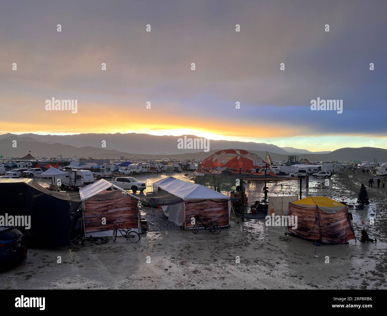 Black Rock, USA. 04th Sep, 2023. The undated photo shows tents between puddles and mud on the grounds of the 'Burning Man' festival. Tens of thousands of visitors to the desert festival 'Burning Man' are stranded on the site in the US state of Nevada after heavy rainfall over the weekend. Credit: David Crane/dpa/Alamy Live News Stock Photo