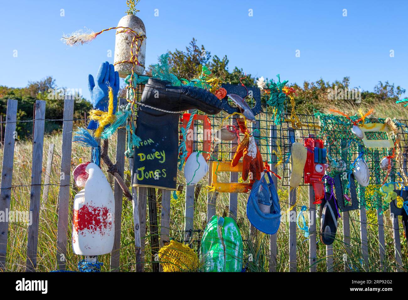 An artistic arrangement of objects on a seaside fence in Newburyport Stock Photo
