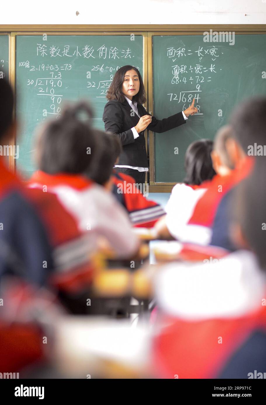 (190327) -- BEIJING, March 27, 2019 (Xinhua) -- A teacher gives a lesson to students at the central primary school of Tuokezhake Township in Shufu County, northwest China s Xinjiang Uygur Autonomous Region, Sept. 26, 2017. China s efforts to promote the balanced development of compulsory education, which usually means narrowing inter-regional, rural-urban or inter-school gaps in terms of education conditions and quality, has borne fruit, the Ministry of Education said Tuesday. According to the ministry, the balanced development of compulsory education has been achieved in 2,717 counties, repre Stock Photo
