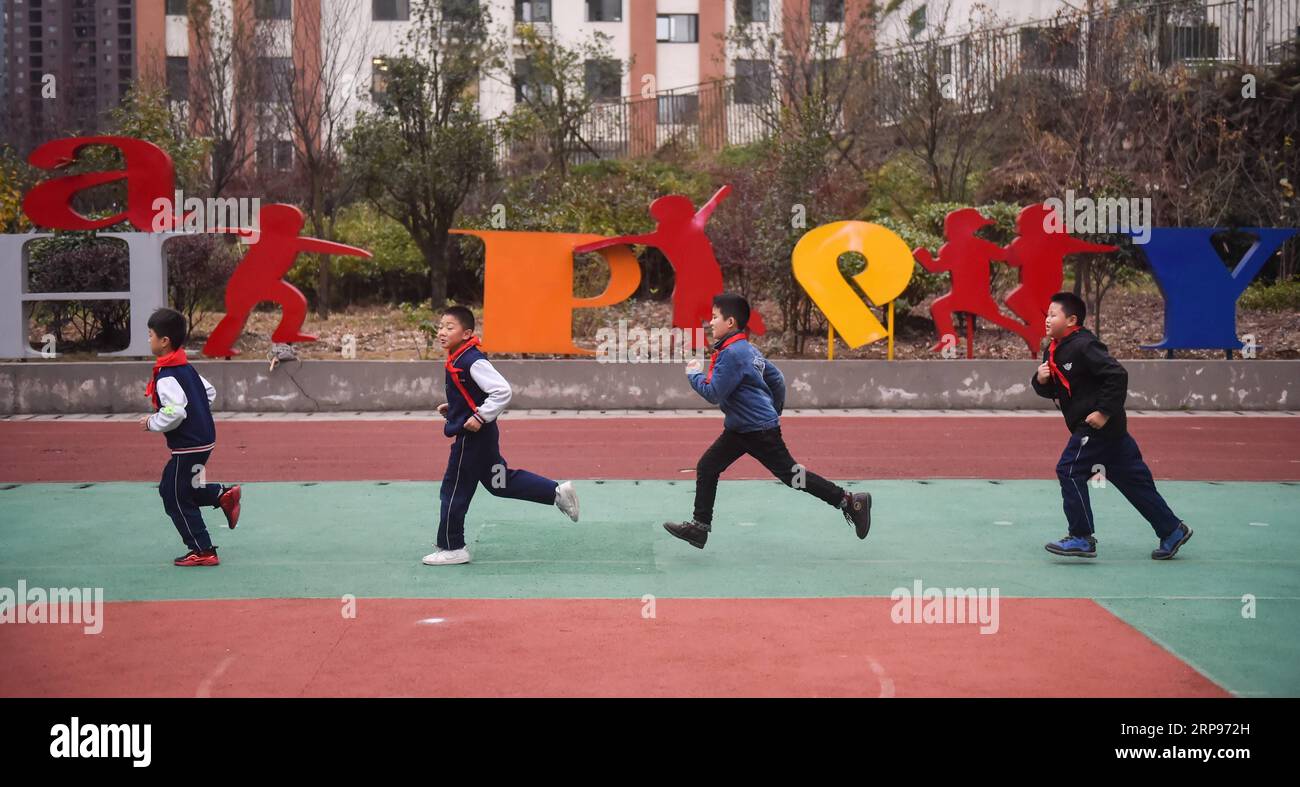 (190327) -- BEIJING, March 27, 2019 (Xinhua) -- Students run on the playground at Anjing School in Qianling Township in Yunyan District of Guiyang City, southwest China s Guizhou Province, Dec. 6, 2018. China s efforts to promote the balanced development of compulsory education, which usually means narrowing inter-regional, rural-urban or inter-school gaps in terms of education conditions and quality, has borne fruit, the Ministry of Education said Tuesday. According to the ministry, the balanced development of compulsory education has been achieved in 2,717 counties, representing 92.7 percent Stock Photo