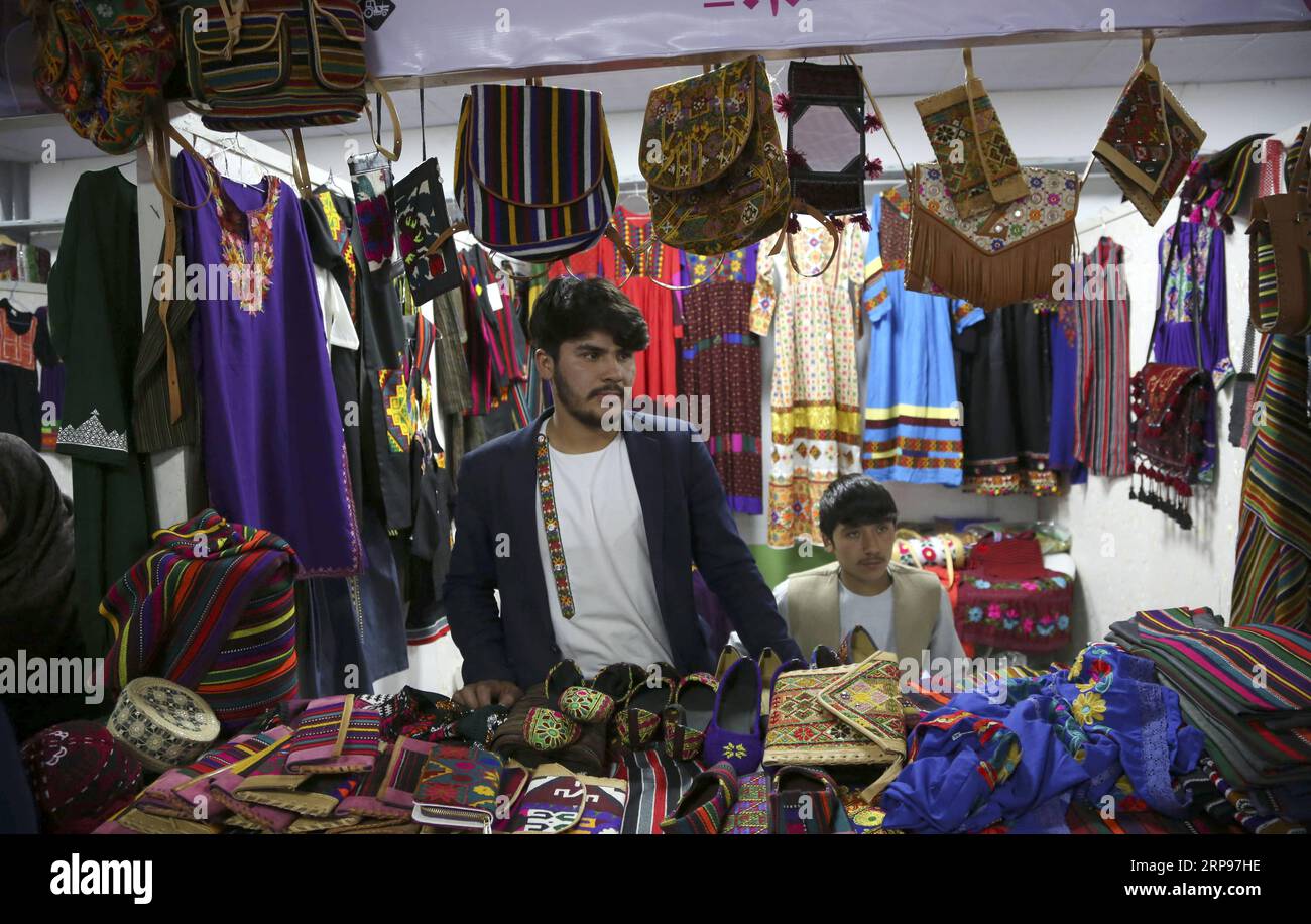 (190327) -- KABUL, March 27, 2019 -- Afghan men wait for costumers during an agriculture and handicrafts exhibition in Kabul, Afghanistan, March 26, 2019. As part of its annual program to exhibit various domestic products, Afghanistan has held its 22nd agriculture and handicrafts exhibition in capital Kabul. The exhibition, which was held from March 22-26 at the Badam Bagh agriculture park, a garden in northern outskirts of Kabul city, was visited by thousands of people from around the country. ) AFGHANISTAN-KABUL-AGRICULTURE AND HANDICRAFTS EXHIBITION RahmatxAlizadah PUBLICATIONxNOTxINxCHN Stock Photo