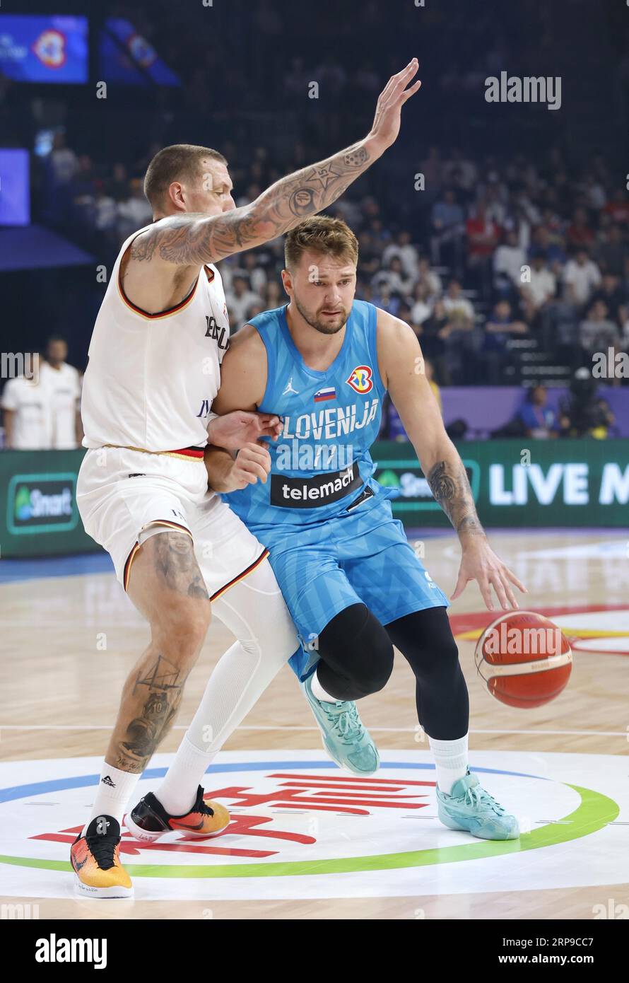 Slovenia's Luka Doncic (R) is guarded by a Germany player during the ...