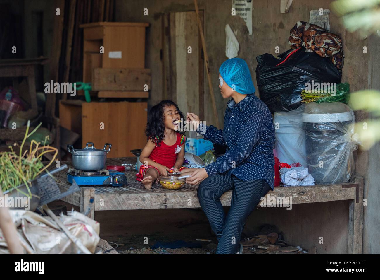 (190402) -- PHNOM PENH, April 2, 2019 (Xinhua) -- Sum Meyle feeds her daughter after receiving a cataract operation at Kampong Cham Provincial Hospital in Kampong Cham, Cambodia, March 15, 2019. Sum Meyle, 36, is a single mother with five children. To help improve their financial conditions, two of Meyle s daughters are now working in the capital Phnom Penh while two of her sons are living in a children s nursing home. Meyle now lives in a rented shanty house with her youngest daughter. Meyle had suffered from cataract after her left eye was injured. Seven months ago, she had almost lost her e Stock Photo