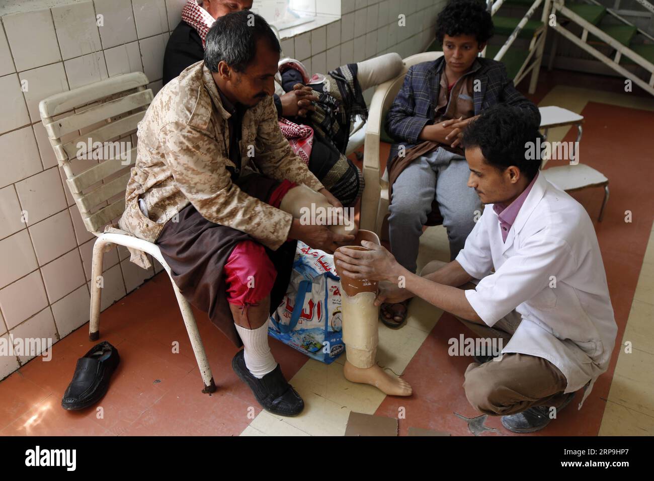 (190407) -- SANAA, April 7, 2019 -- A doctor offers a landmine victim a prosthetic limb at a rehabilitation center in Sanaa, Yemen, on April 7, 2019. Large swathes of Yemen have been swamped by randomly-planted landmines, which are posing a lingering threat to the lives of citizens across the war-torn country. According to the United Nations, thousands of landmines, unexploded ordnance and other explosive war remnants have been left behind during the ongoing conflict in Yemen which has just entered its fifth year. ) YEMEN-SANAA-LANDMINES-VICTIMS MohammedxMohammed PUBLICATIONxNOTxINxCHN Stock Photo