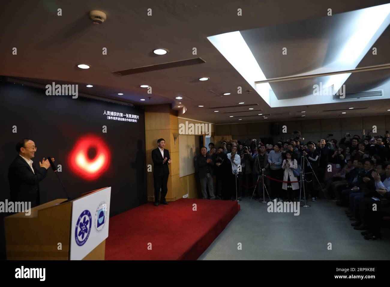 (190410) -- SHANGHAI, April 10, 2019 (Xinhua) -- Shanghai Astronomical Observatory (SAO) holds a press conference to release the first-ever image of a supermassive black hole at the heart of the distant galaxy M87, in east China s Shanghai, April 10, 2019. The image of the black hole, based on observations through the Event Horizon Telescope (EHT), a planet-scale array of eight ground-based radio telescopes forged through international collaboration, was unveiled in coordinated press conferences across the globe at around 9:00 p.m. (Beijing time) on Wednesday. The landmark result offers scient Stock Photo