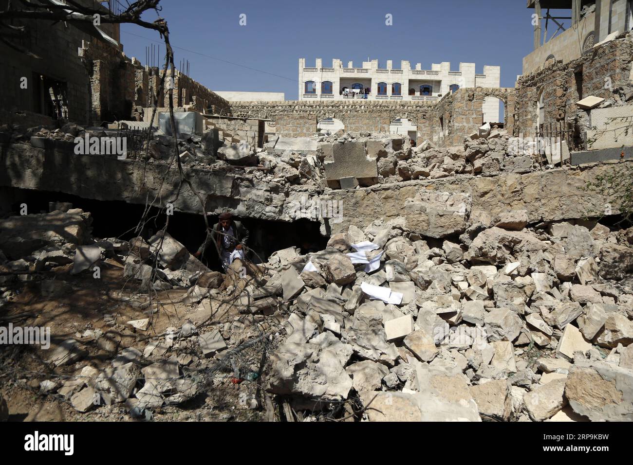 (190410) -- SANAA, April 10, 2019 -- A man inspects a house after it was hit by an airstrike in the early morning in Sanaa, Yemen, April 10, 2019. Saudi-led coalition involved in a war in Yemen struck on Wednesday two targets in Sanaa, Al Arabiya TV reported. The coalition spokesperson Turki al-Maliki said that the strikes targeted Houthi drones manufacturing plant and a store containing launch pads. There were no immediate reports of any casualties or damage. Mohammed Mohammed) YEMEN-SANAA-AIRSTRIKE nieyunpeng PUBLICATIONxNOTxINxCHN Stock Photo