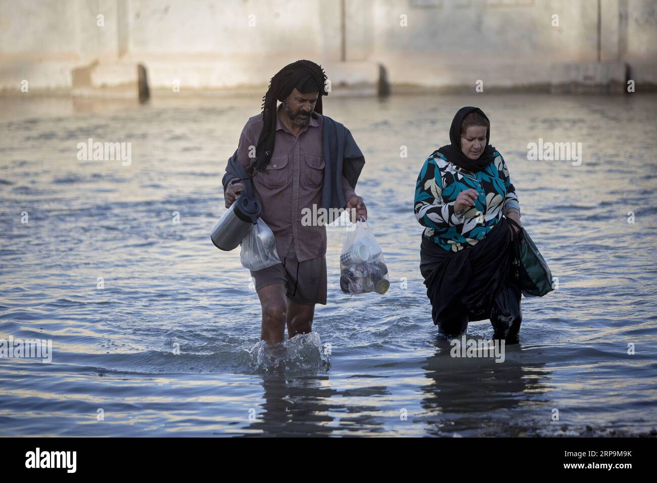 (190411) -- KHUZESTAN, April 11, 2019 -- People wade through flood water at a village in Khuzestan province, southwestern Iran, on April 10, 2019. ) IRAN-KHUZESTAN-FLOOD AhmadxHalabisaz PUBLICATIONxNOTxINxCHN Stock Photo