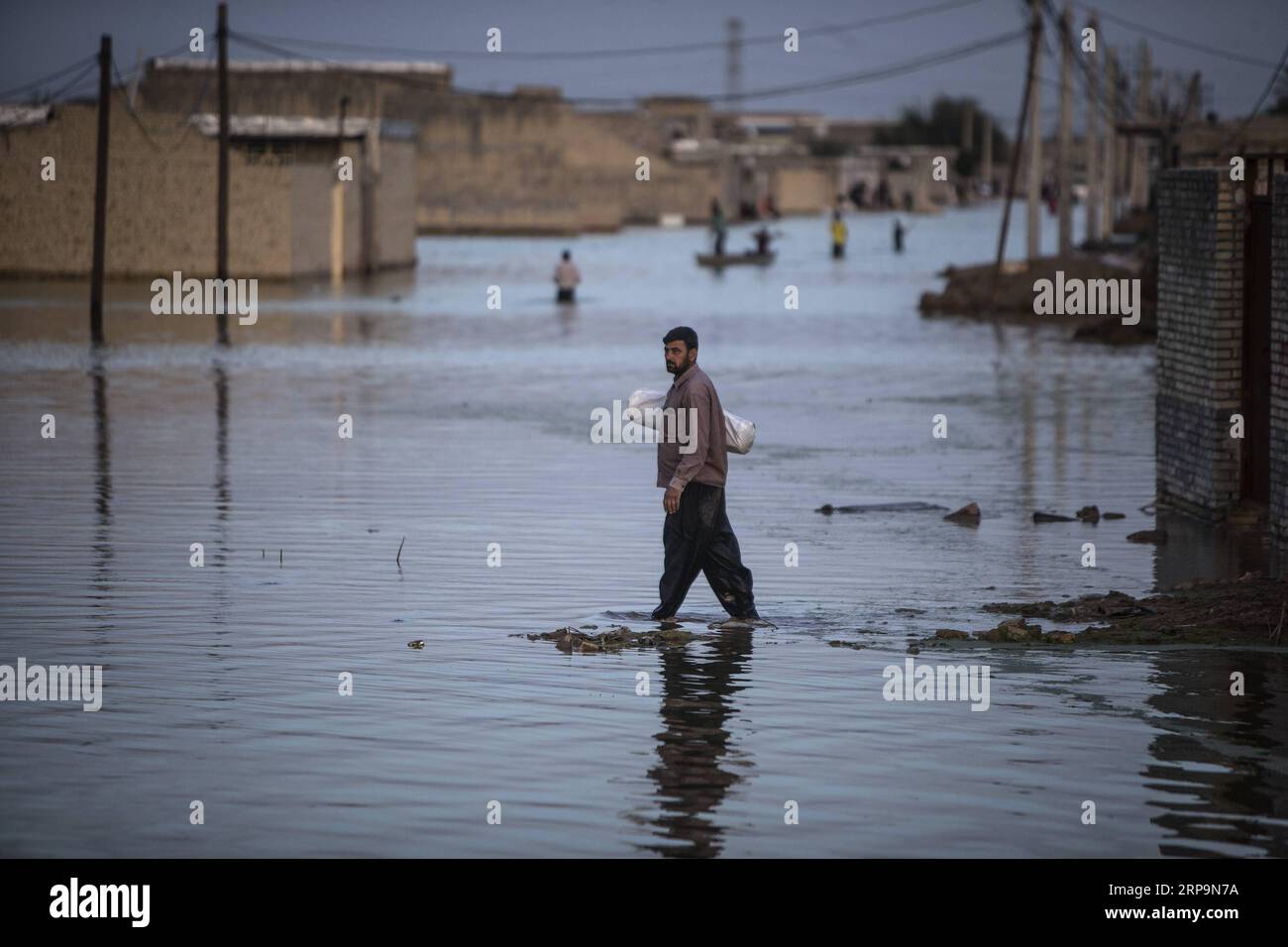 (190412) -- AHVAZ, April 12, 2019 -- People wade through flood waters just outside Ahvaz city, capital of Khuzestan province, Iran, April 11, 2019. ) IRAN-AHVAZ-FLOOD AhmadxHalabisaz PUBLICATIONxNOTxINxCHN Stock Photo