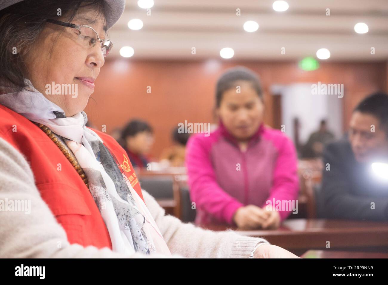 (190413) -- TONGLU, April 13, 2019 (Xinhua) -- Wu Suhuan (L) prepares to read her script to narrate the film Kekexili: Mountain Patrol for visually impaired people in Tonglu Branch of China Braille Library in Tonglu County, east China s Zhejiang Province, April 11, 2019. Wu Suhuan, 65, is a progressive muscular atrophy patient and has been paralyzed for decades. Dedicated to working as a narrator for barrier-free movies, she has so far wrote scripts for four movies and read them along with the movie for the visually impaired since 2015. I feel happy and fulfilled in helping them, said Wu. (Xin Stock Photo