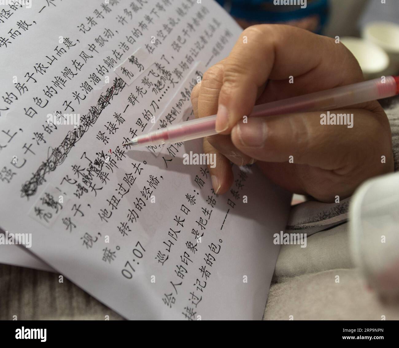 (190413) -- TONGLU, April 13, 2019 (Xinhua) -- Wu Suhuan modifies her script to narrate the film Kekexili: Mountain Patrol for the visually impaired people in Tonglu Branch of China Braille Library in Tonglu County, east China s Zhejiang Province, April 11, 2019. Wu Suhuan, 65, is a progressive muscular atrophy patient and has been paralyzed for decades. Dedicated to working as a narrator for barrier-free movies, she has so far wrote scripts for four movies and read them along with the movie for the visually impaired since 2015. I feel happy and fulfilled in helping them, said Wu. (Xinhua/Weng Stock Photo