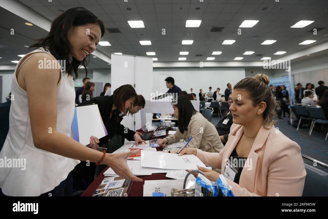 (190415) -- LOS ANGELES, April 15, 2019 (Xinhua) -- A job hunter talks with an employer during the second CUAAASC Career Development Forum and Expo in Los Angeles, the United States, April 13, 2019. The career event was co-hosted by the Chinese University Alumni Association Alliance of Southern California (CUAAASC), an organization consisting of 50 Chinese university alumni associations including well known schools such as Tsinghua University and Peking University, and YLB Education Technology Inc. (YLB), an education platform that provides dedicated connections between international students Stock Photo