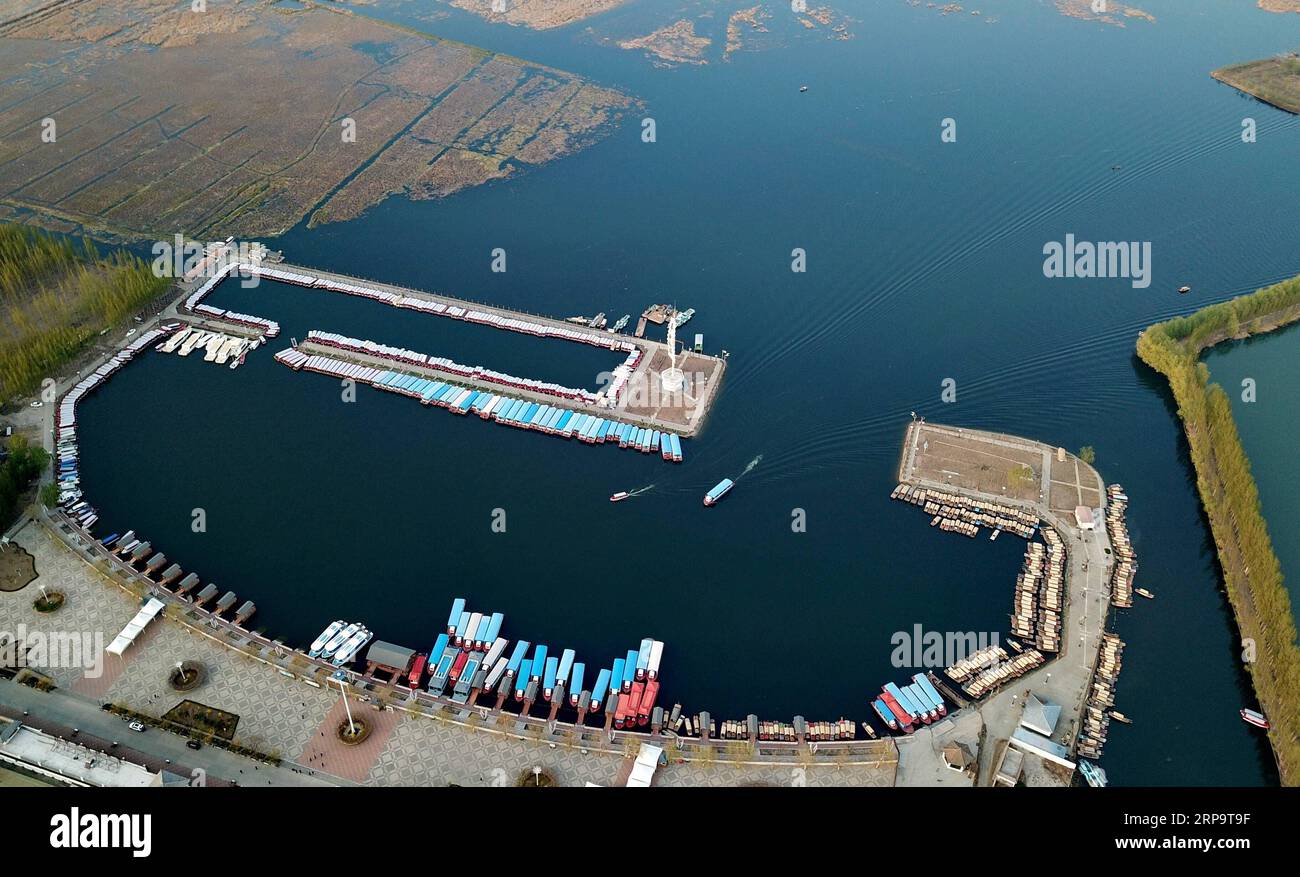 (190416) -- SHIJIAZHUANG, April 16, 2019 (Xinhua) -- Aerial photo taken on April 10, 2019 shows tourist boats sailing near a pier on the Baiyangdian lake in Xiongan New Area, north China s Hebei Province. Restoration work has started in Baiyangdian Lake, northern China s largest freshwater body. High-pollution and energy-intensive production has been tackled. As a result, water quality has improved remarkably. (Xinhua/Mu Yu) CHINA-HEBEI-XIONGAN-BAIYANGDIAN (CN) PUBLICATIONxNOTxINxCHN Stock Photo