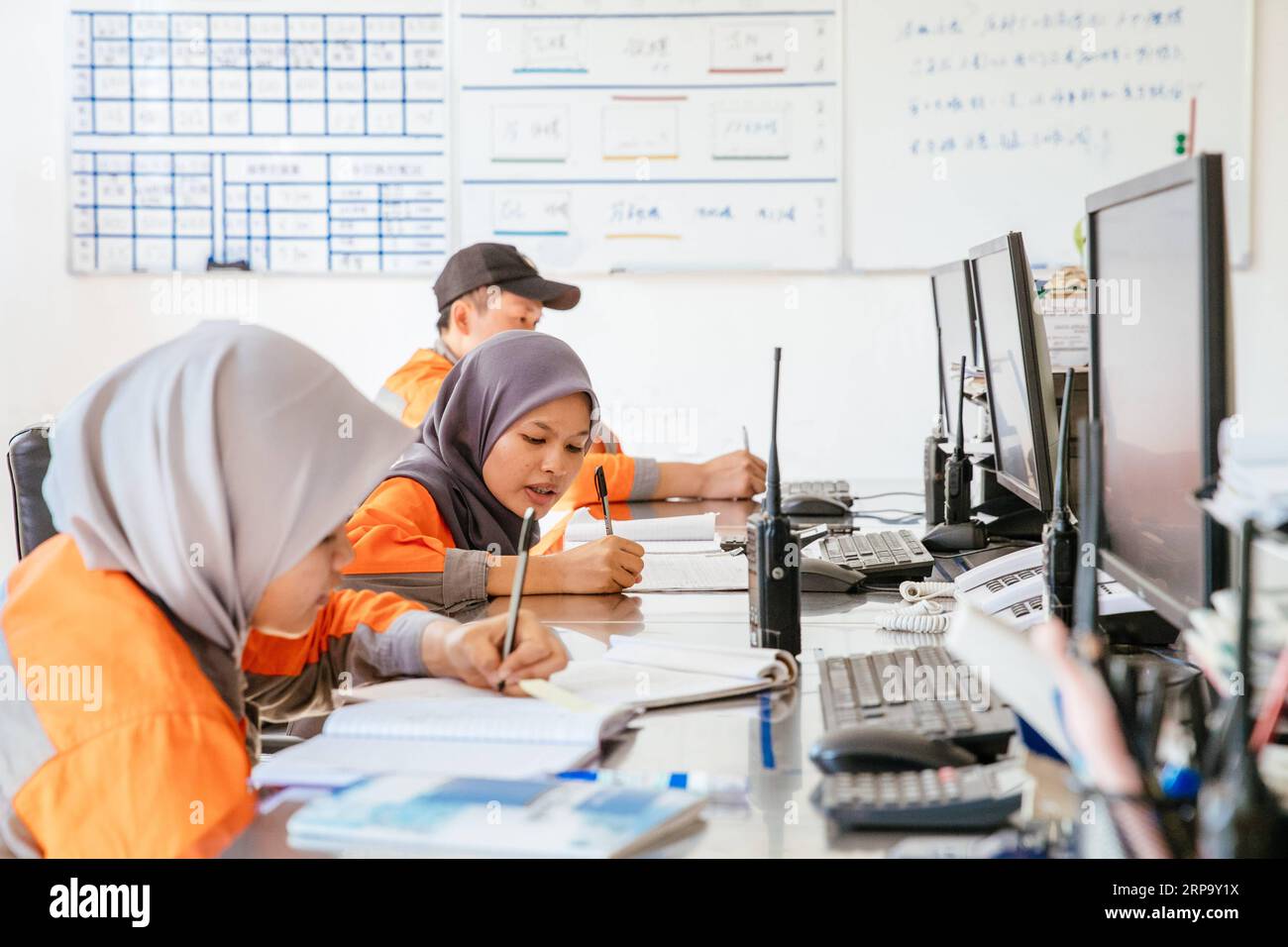 (190419) -- KUALA LUMPUR, April 19, 2019 (Xinhua) -- Nur Fatihah Binti Zakaria (2nd L) works at the coal preparation central control room at the Alliance Steel coking plant in Kuantan, Malaysia, April 15, 2019. At the beginning Malaysian college graduate Nur Fatihah Binti Zakaria had no idea about what steel production was all about, nor did she have any knowledge about speaking Chinese. But after almost two years working at the Alliance Steel at the Malaysia, China Kuantan Industrial Park, she now can perform her job skillfully, even making fun of her colleagues from China that not all of the Stock Photo