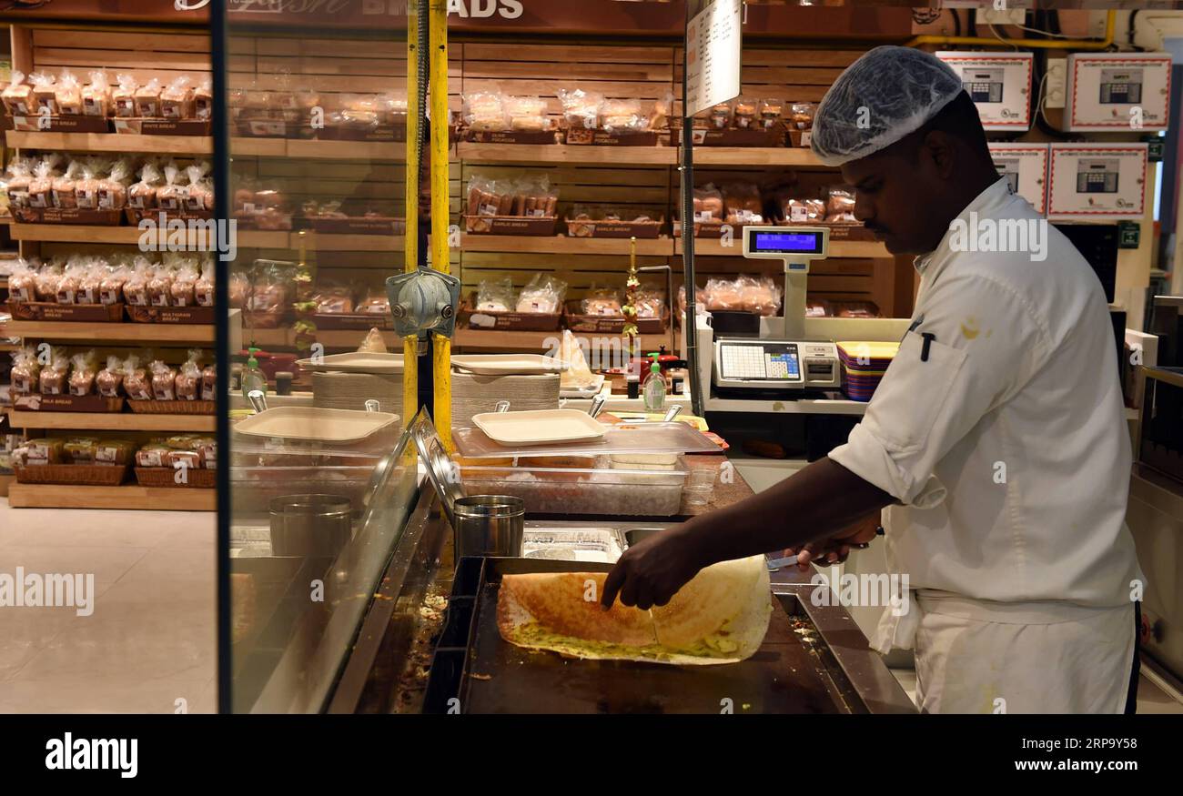 (190419) -- NEW DELHI, April 19, 2019 (Xinhua) -- An Indian chef makes Dosa for a customer at a supermarket in New Delhi, India, April 18, 2019. Dosa, a crispy paper-thin wrap with a spicy potato filling, eaten dipped in a tangy soup and a special sauce or chutney, is popular in southern India. (Xinhua/Zhang Naijie) INDIA-NEW DELHI-DOSA PUBLICATIONxNOTxINxCHN Stock Photo
