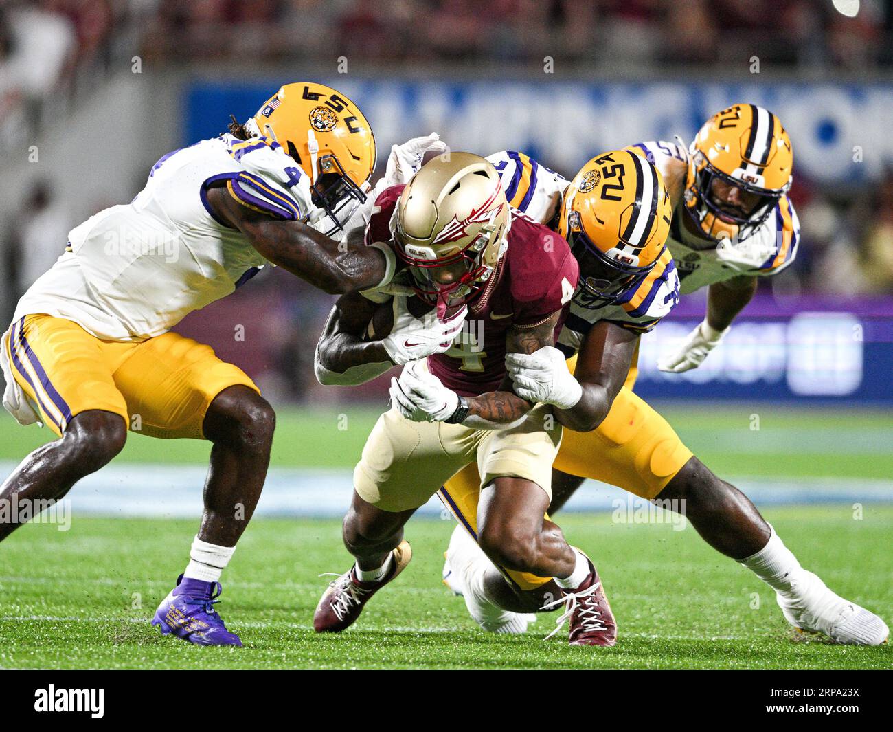 September 3, 2023: Florida State Seminoles wide receiver Keon Coleman (4) is tackled by a pair of LSU Tigers defenders during the 2nd half of the Camping World Kickoff between LSU Tigers and Florida State Seminoles. FSU defeated LSU 45-24 at Camping World Stadium in Orlando, FL. Romeo T Guzman/CSM Stock Photo