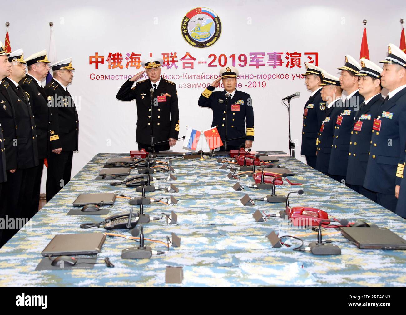 (190429) -- QINGDAO, April 29, 2019 (Xinhua) -- Qiu Yanpeng (C, R), chief director of Joint Sea-2019 exercise from the Chinese side and deputy commander of the Chinese People s Liberation Army (PLA) Navy, and Alexander Vitko (C, L), chief director of the exercise from the Russian side and deputy commander-in-chief of the Russian Navy, attend the opening ceremony of the Sino-Russian Joint Sea-2019 exercise in Qingdao, east China s Shandong Province, April 29, 2019. Russian naval vessels arrived in Qingdao on Monday to participate in the Sino-Russian Joint Sea-2019 exercise. The exercise will fo Stock Photo