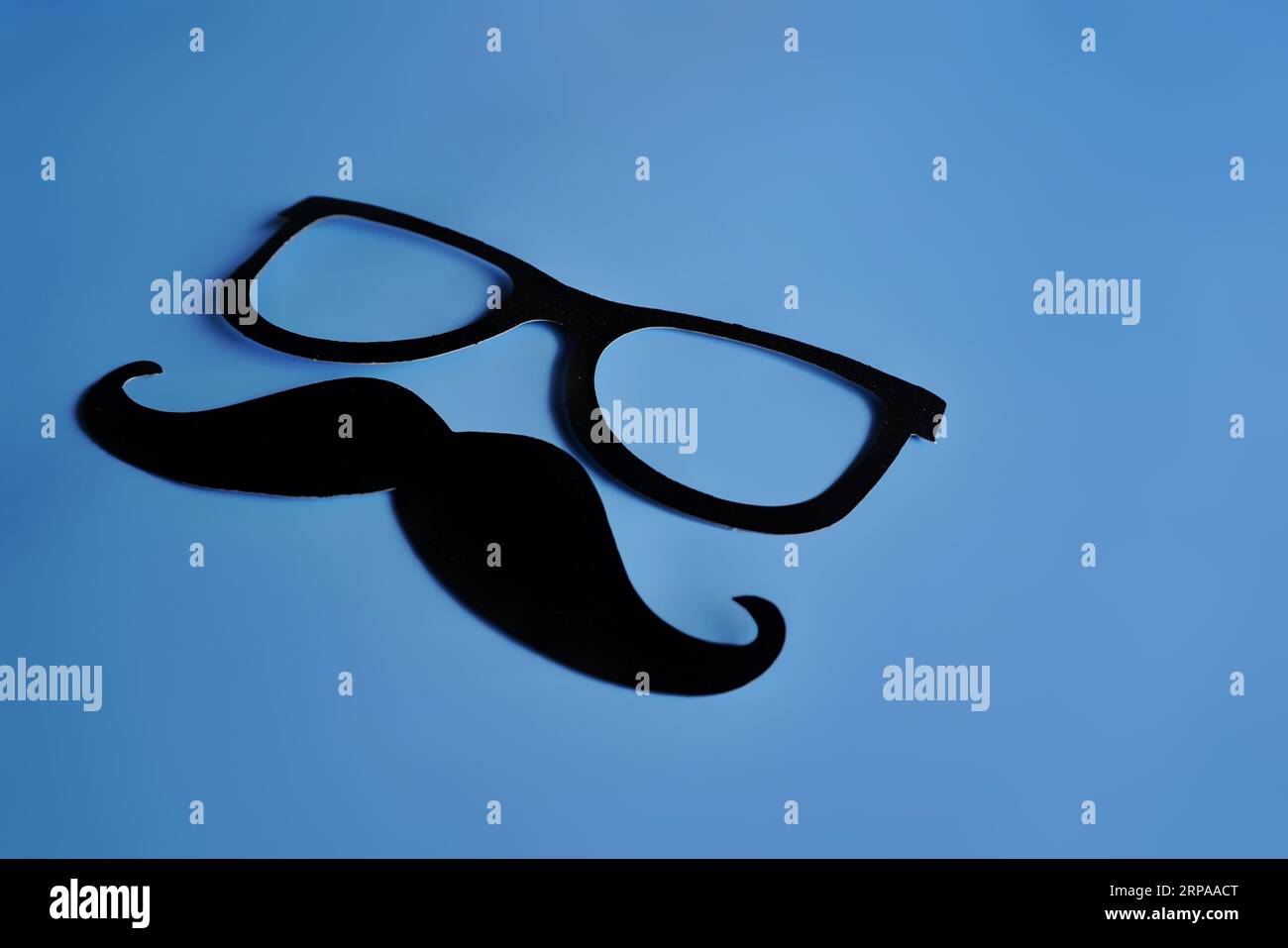 Mustache and glasses on blue background with copy space.  Movember, men's health concept Stock Photo