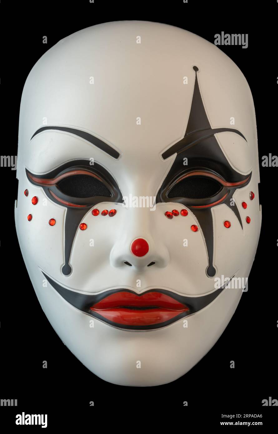 Scary Jester Half Mask isolated on black. Stock Photo