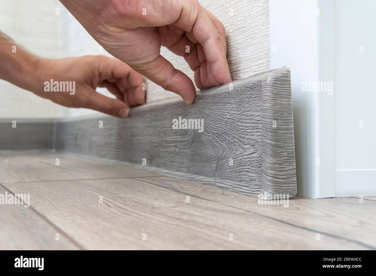 installing the floor skirting board. dismantling of the plastic
