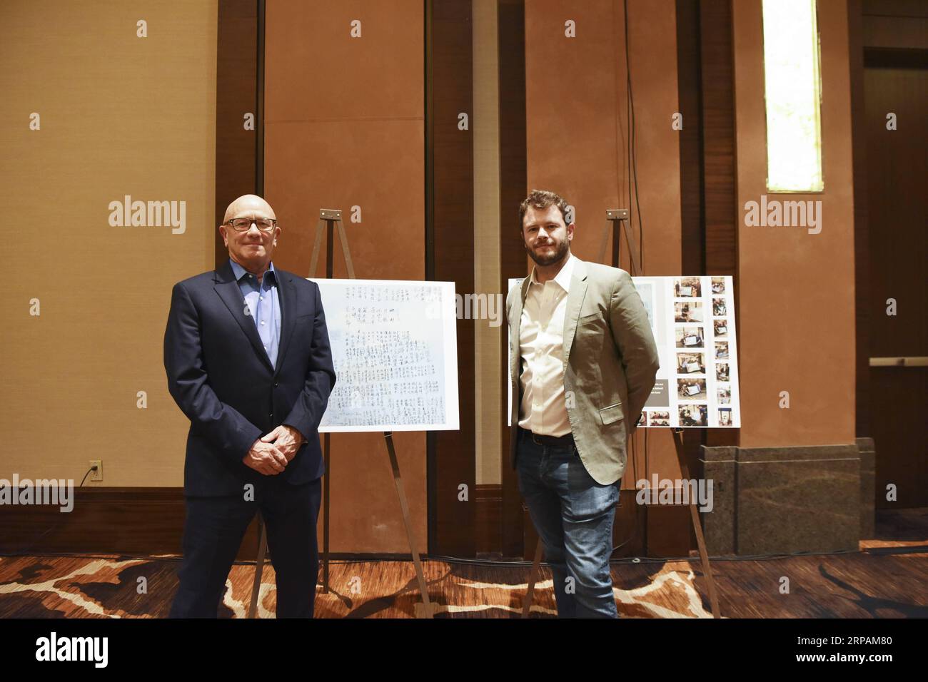 (190514) -- NEW YORK, May 14, 2019 -- James Bryant (L) and his son Ben Bryant pose in front of the memorial posters at the 4th Sino-American Second World War Friendship and Flying Tiger History Conference in Las Vegas, the United States, May 11, 2019. James Bryant will never forget the day when his 93-year-old father went back to his bedroom and came back with a flight brief case containing papers related to the training and assignments he took as a U.S. Flying Tiger pilot during the World War II. As a remarkable yet humble man and a loving father, James E. Bryant did not show any detailed evi Stock Photo